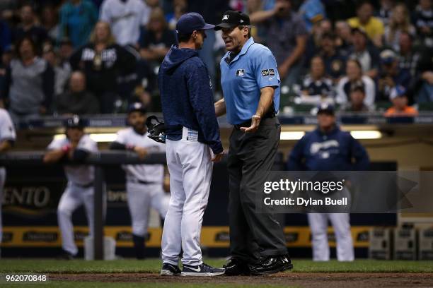 Manager Craig Counsell of the Milwaukee Brewers argues with umpire Angel Hernandez in the ninth inning against the Arizona Diamondbacks at Miller...