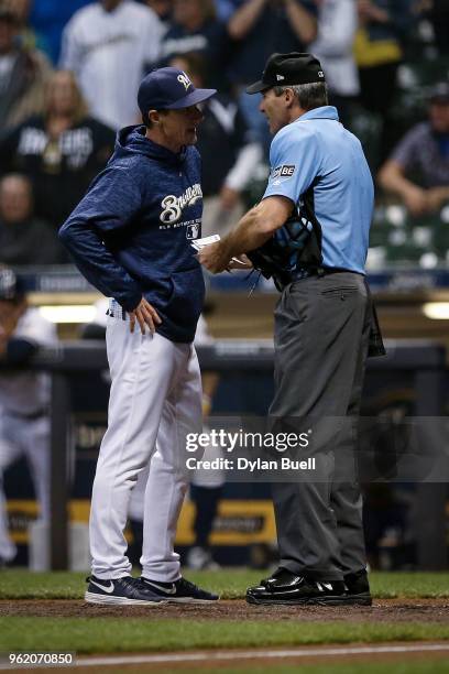 Manager Craig Counsell of the Milwaukee Brewers argues with umpire Angel Hernandez in the ninth inning against the Arizona Diamondbacks at Miller...