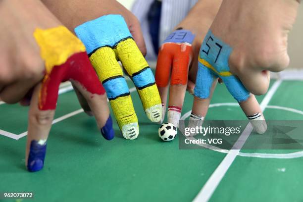 College students participate in a finger soccer game held by Academy of Fine Arts at Liaocheng University on May 24, 2018 in Jinan, China.