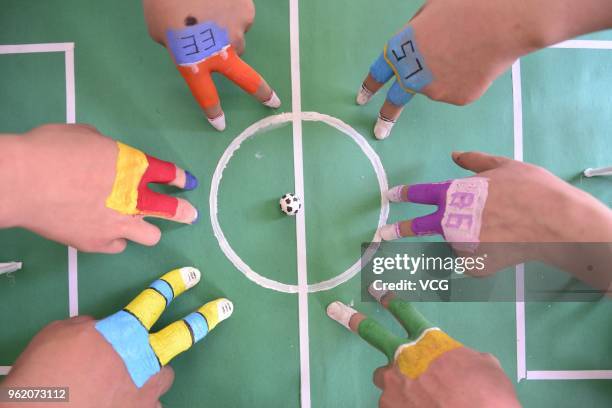 College students participate in a finger soccer game held by Academy of Fine Arts at Liaocheng University on May 24, 2018 in Jinan, China.