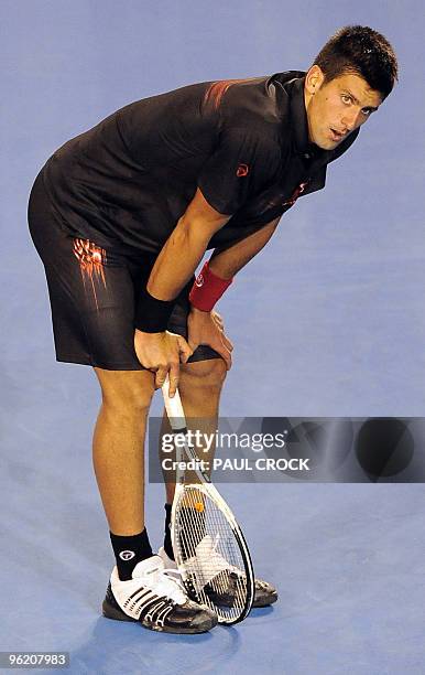 Novak Djokovic of Serbia reacts during his loss to Jo-Wilfried Tsonga of France in their men's singles quarter-final match on day 10 of the...