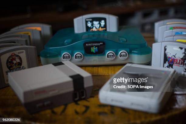 In this photo illustration, a Japanese edition of the Nintendo 64 clear blue version with a bunch of games next to a Nintendo Classic Mini 'Nintendo...