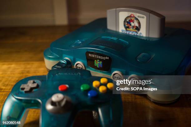 In this photo illustration, a Japanese edition of the Nintendo 64 clear blue version with a cartridge of Mario Kart 64 plugged in. The Nintendo 64...