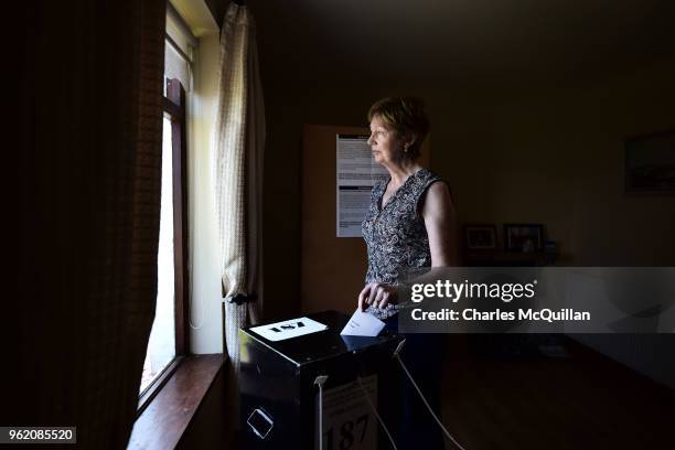 Maureen Ui Fhearraigh casts her ballot paper as voting takes place a day earlier than the main land on May 24, 2018 in Gola Island, Ireland. Ireland...