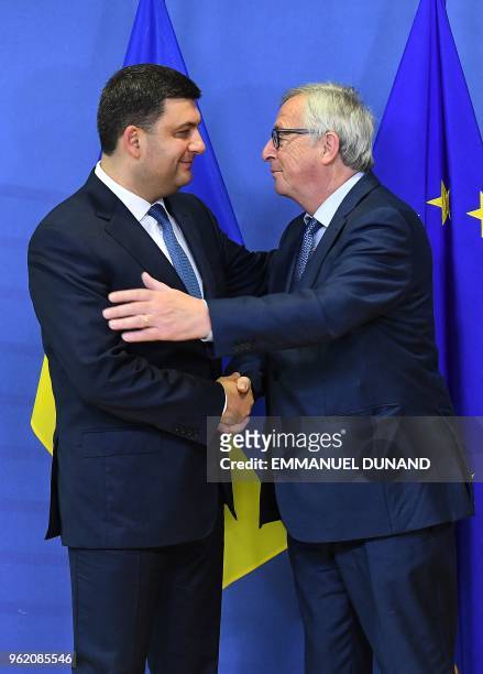 Ukraine's Prime Minister Volodymyr Groysman is welcomed by European Commission President Jean-Claude Juncker before a metting at the European...