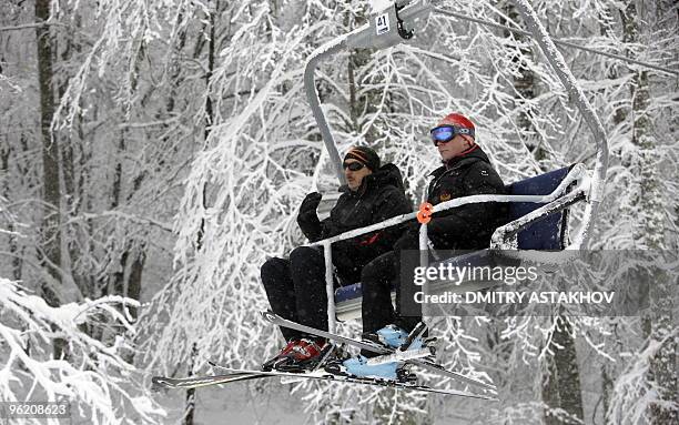 Picture taken on January 25, 2010 shows Russian President Dmitry Medvedev and Azerbaijani President Ilham Aliyev riding a chair lift at the Krasnaya...