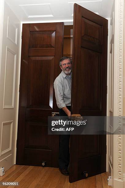 Sinn Fein President Gerry Adams smiles after he re-enters a press conference at Hillsborough Castle in Hillsborough, Northern Ireland January 27,...