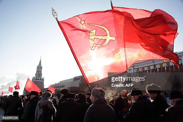 Members of the Russian Communist Party go to lay flowers at the Mausoleum of Soviet leader Vladimir Lenin on Red Square in Moscow on January 21, 2010...