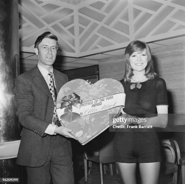 Dominic Cadbury, director of the Cadbury Schweppes confectionery and soft drinks company, presents a special presentation box of chocolates to...