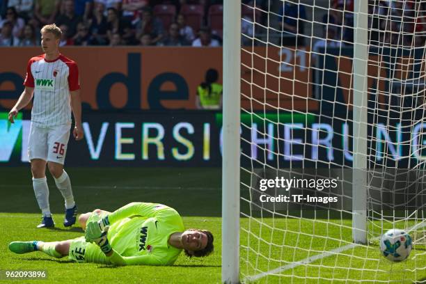 Thilo Kehrer of Schalke scores the team`s first goal and Martin Hinteregger of Augsburg and Goalkeeper Marvin Hitz of Augsburg look on during the...