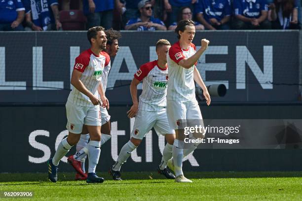 Philipp Max of Augsburg celebrates after scoring his team`s first goal with Rani Khedira of Augsburg, Francisco da Silva Caiuby of Augsburg and...