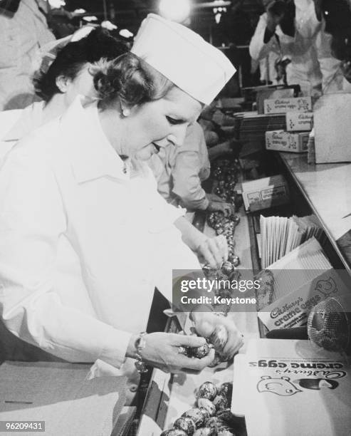 British Conservative Party leader Margaret Thatcher packing Creme Eggs on a visit to the Cadbury factory in Birmingham during her election tour of...