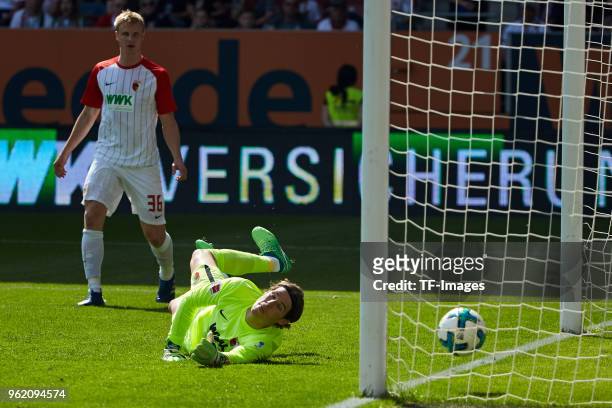 Thilo Kehrer of Schalke scores the team`s first goal and Goalkeeper Marvin Hitz of Augsburg looks on during the Bundesliga match between FC Augsburg...