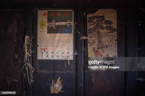 An old calendar from 1997 seen hanging on the wall of an abandonned traditional Chinese wooden house in Shaxi.