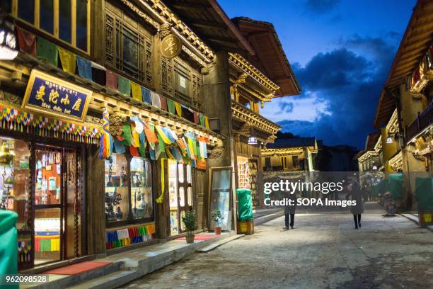 People seen walking in the old city of Shangri-La during the night.