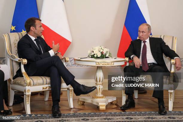 Russian President Vladimir Putin meets with his French counterpart Emmanuel Macron at the Konstantin Palace in Strelna, outside Saint Petersburg, on...