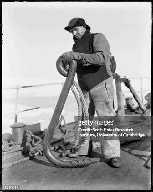 Bosun Alfred B. Cheetham with the ship's ice anchor, during Captain Robert Falcon Scott's Terra Nova Expedition to the Antarctic, December 1910.