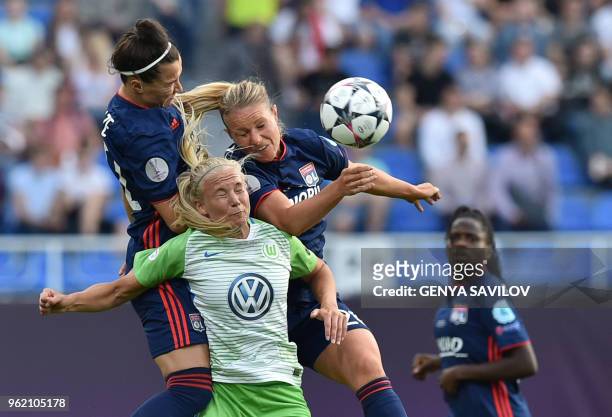 Wolfsburg's Danish forward Pernille Harder vies with Olympique Lyonnais' English defender Lucy Bronze and Olympique Lyonnais' French midfielder...