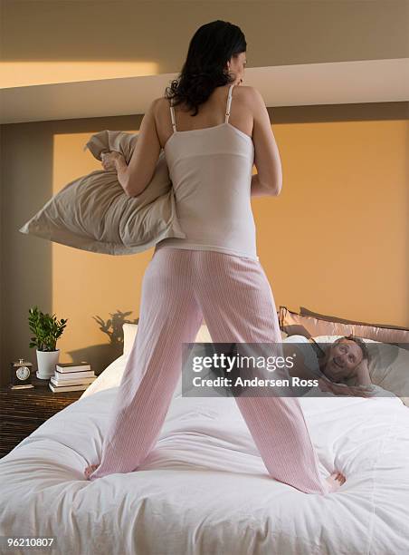 couple having pillow fight in bed - naughty wife fotografías e imágenes de stock