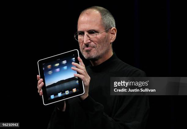 Apple Inc. CEO Steve Jobs holds up the new iPad as he speaks during an Apple Special Event at Yerba Buena Center for the Arts January 27, 2010 in San...