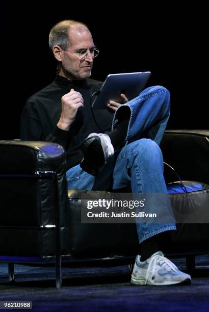 Apple Inc. CEO Steve Jobs demonstrates the new iPad as he speaks during an Apple Special Event at Yerba Buena Center for the Arts January 27, 2010 in...