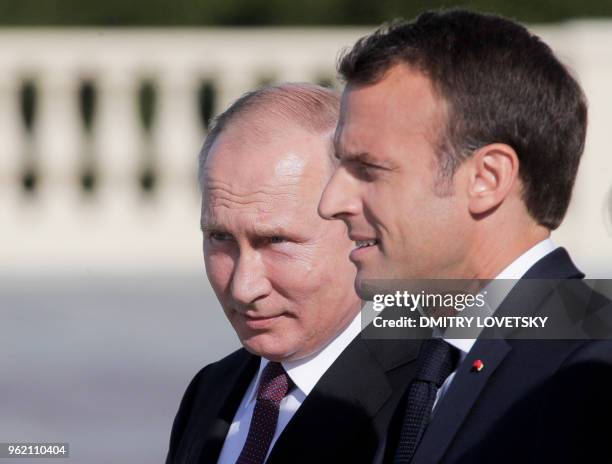 Russian President Vladimir Putin welcomes French President Emmanuel Macron at the Konstantin Palace in Strelna, outside Saint Petersburg, on May 24,...