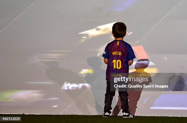 Thiago Messi looks at the screen the image of his father Lionel Messi of FC Barcelona after the La Liga match between Barcelona and Real Sociedad at...