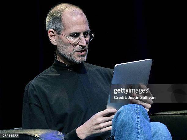 Apple Inc. CEO Steve Jobs demonstrates the new iPad as he speaks during an Apple Special Event at Yerba Buena Center for the Arts January 27, 2010 in...