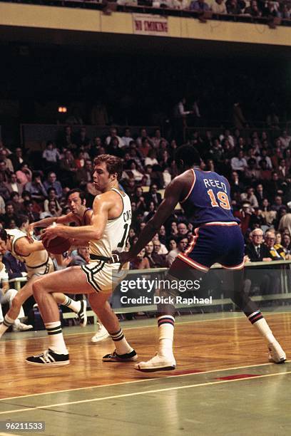 Dave Cowens of the Boston Celtics makes a move to the basket against Willis Reed of the New York Knicks during a game played in 1972 at the Boston...