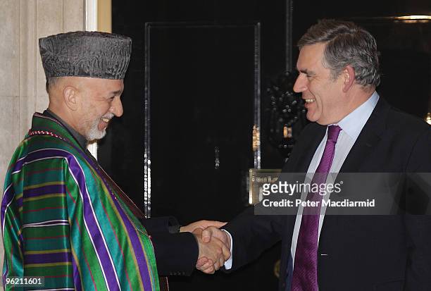 British Prime Minister Gordon Brown shakes hands with Afghan President Hamid Karzai at 10 Downing Street on January 27, 2010 in London, England. The...
