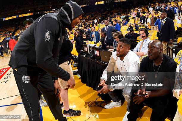 David West of the Golden State Warriors talks with Anthony Joshua prior to Game Four of the Western Conference Finals during the 2018 NBA Playoffs...