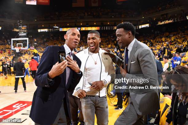 Anthony Joshua talks with Reggie Miller prior to Game Four of the Western Conference Finals during the 2018 NBA Playoffs between the Houston Rockets...