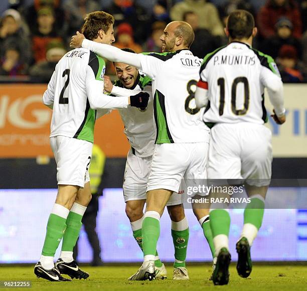 Racing's defender Henrique Adriano Buss celebrates with teammates afer scoring against Osasuna during the Spanish King's Cup quarter final second leg...