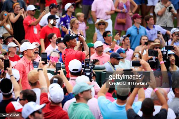 Tiger Woods of the United States plays his shot from the third tee as Jordan Spieth of the United States looks on during the final round of THE...