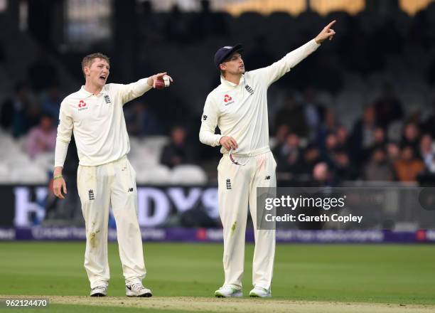 Dominic Bess of England sets his field alongside captain Joe Root during the NatWest 1st Test match between England and Pakistan at Lord's Cricket...