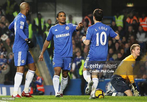 Joe Hart of Birmingham City looks dejected as Florent Malouda of Chelsea celebrates with Nicolas Anelka and Joe COle as he scores their first goal...