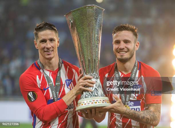 Fernando Torres and Saúl Ñíguez pose with trophy after Atletico Madrid win the UEFA Europa League Final between Olympique de Marseille and Club...