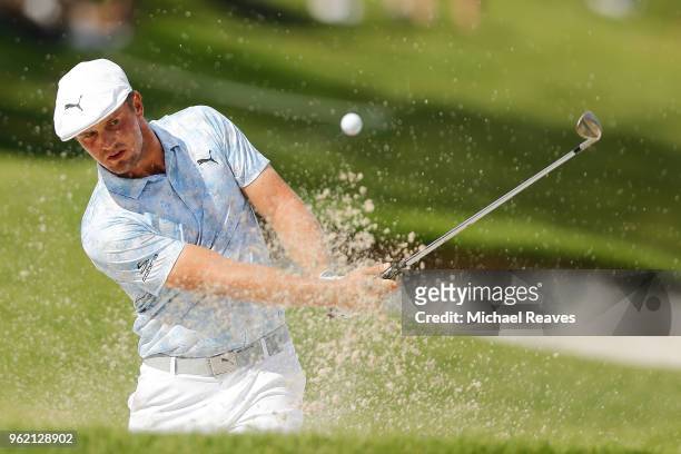 Bryson DeChambeau plays a shot from a bunker on the 18th hole during round one of the Fort Worth Invitational at Colonial Country Club on May 24,...