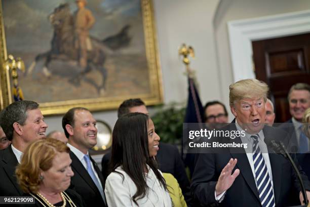 President Donald Trump, right, speaks before signing S. 2155, the Economic Growth, Regulatory Relief, And Consumer Protection Act, with...