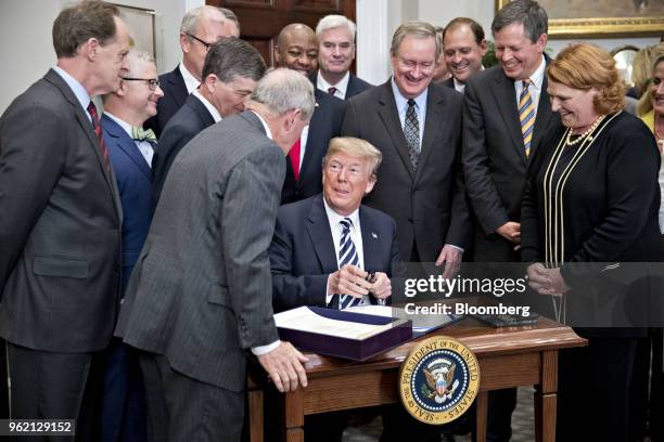 President Donald Trump, center, prepares to sign S. 2155, the Economic Growth, Regulatory Relief, And Consumer Protection Act, with administration...