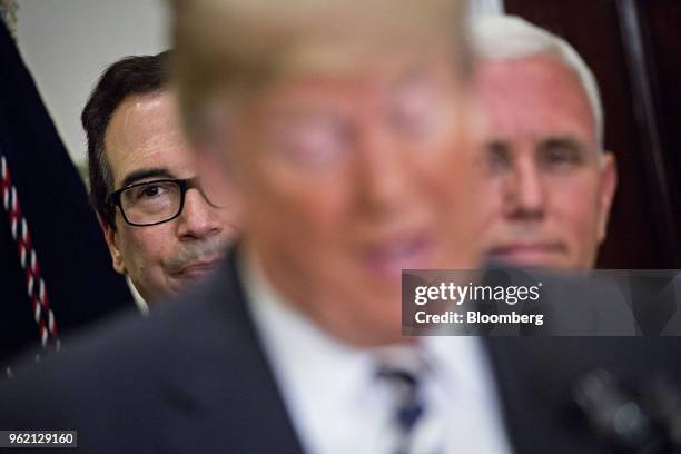 Steven Mnuchin, U.S. Treasury secretary, left, and U.S. Vice President Mike Pence, right, listen as U.S. President Donald Trump speaks before signing...