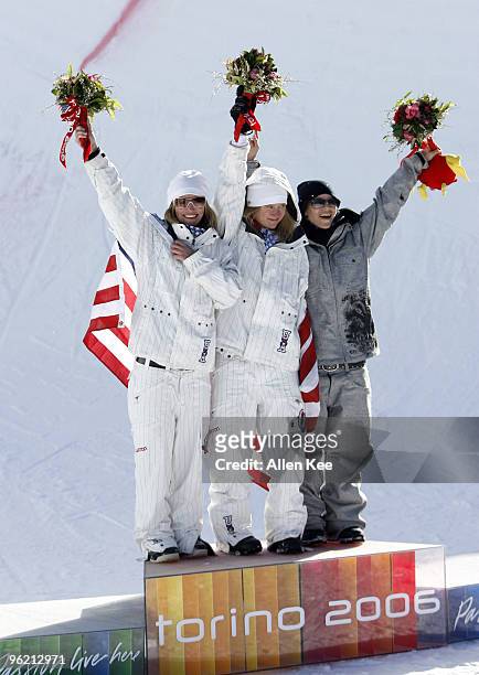 Gretchen Bleiler and Hannah Teter of the United States celebrate with Kjersti Buaas of Norway on the medal podium during the Women's Snowboard...