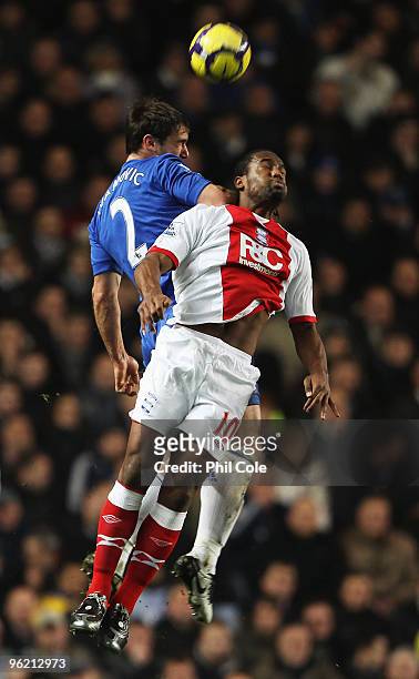 Branislav Ivanovic of Chelsea jumps with Cameron Jerome of Birmingham City during the Barclays Premier League match between Chelsea and Birmingham...