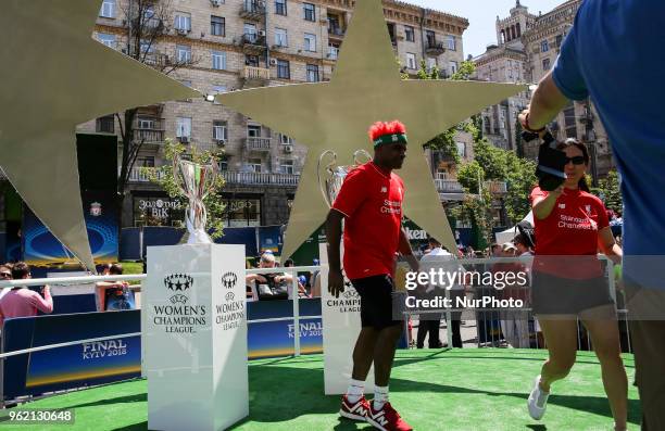 Fans of Liverpool FC take a picture in front of UEFA Champions League Cups at a fan zone in Kyiv, Ukraine, May 24, 2018. Official UEFA Champions...