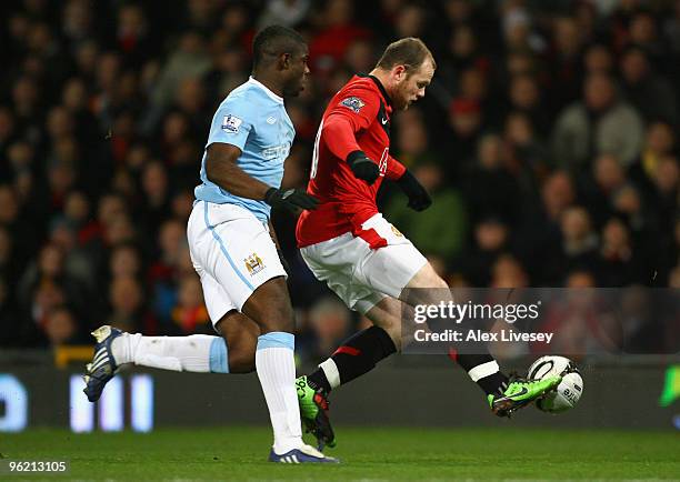 Wayne Rooney of Manchester United controls the ball under pressure from Micah Richards of Manchester City during the Carling Cup Semi Final second...