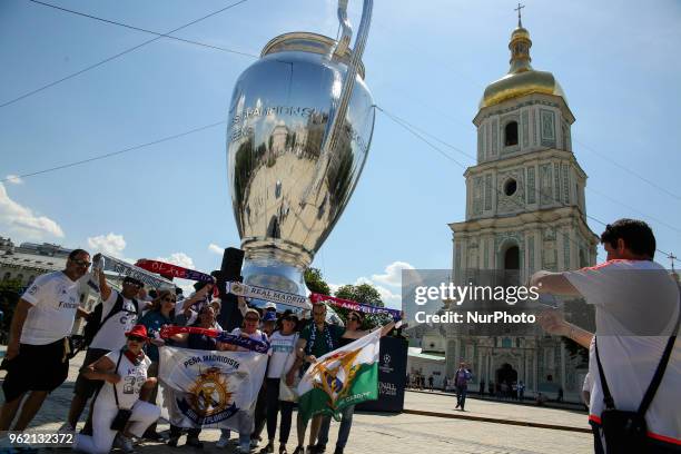 Real Madrid and Liverpool FC fans take a selfie iin front of giant replica of the UEFA Champions League Cup set up near the Saint Sophia's Cathedral...