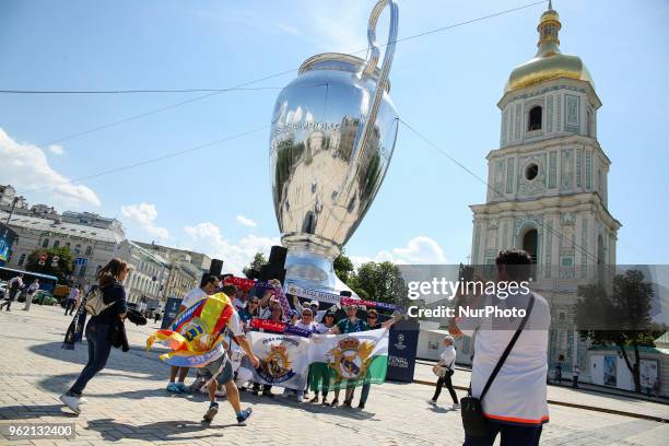 Real Madrid and Liverpool FC fans take a selfie iin front of giant replica of the UEFA Champions League Cup set up near the Saint Sophia's Cathedral...