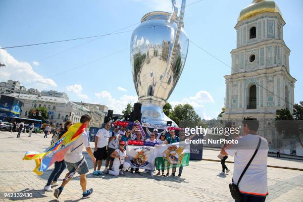Real Madrid and Liverpool FC fans take a selfie iin front of giant replica of the UEFA Champions League Cup set up near the Saint Sophia's Cathedral...