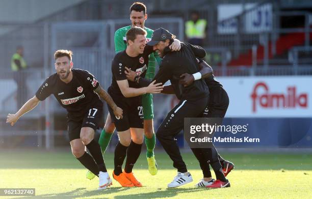 Maximilian Zimmer of Cottbus jubilates with team mates and head coach Claus Dieter Wollitz after scoring the third goal during the Third League...