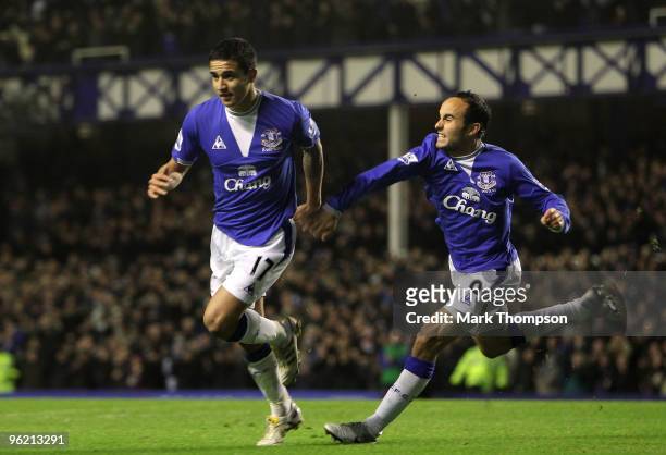 Tim Cahill of Everton celebrates his goal with team mate Landon Donovan a goal during the Barclays Premier League match between Everton and...